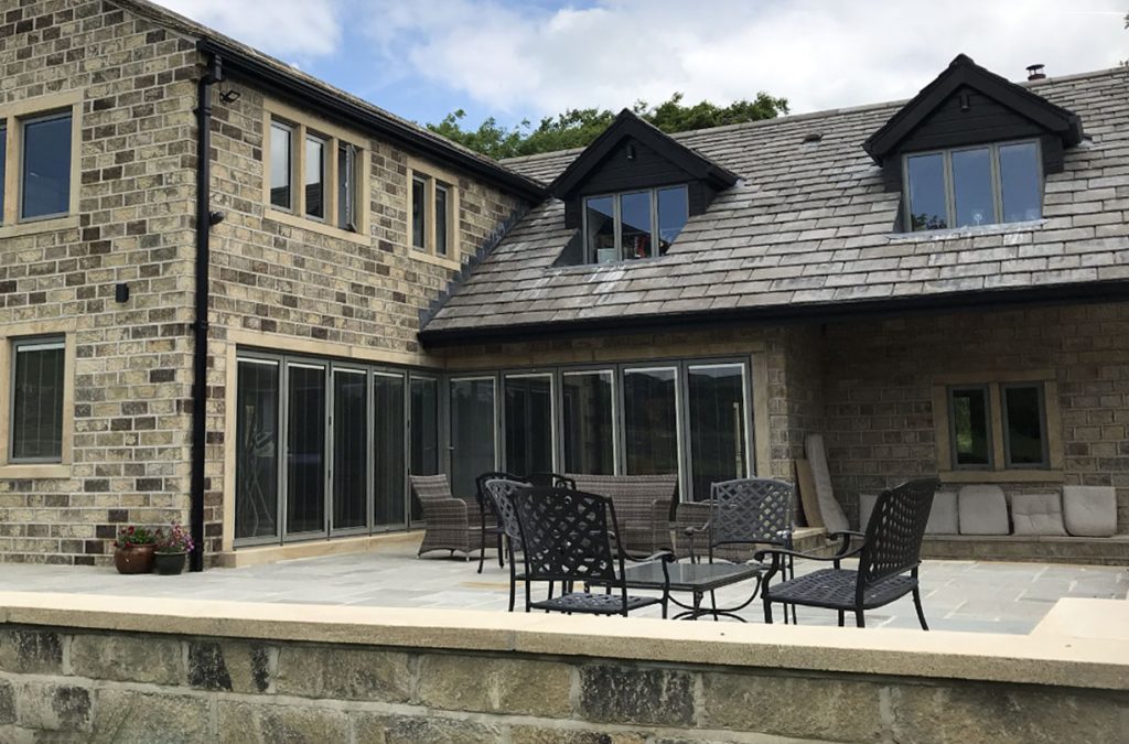 Exterior of modern Yorkshire home overlooking the garden area fitted with Bi-Folding doors installed by Valley Way Construction