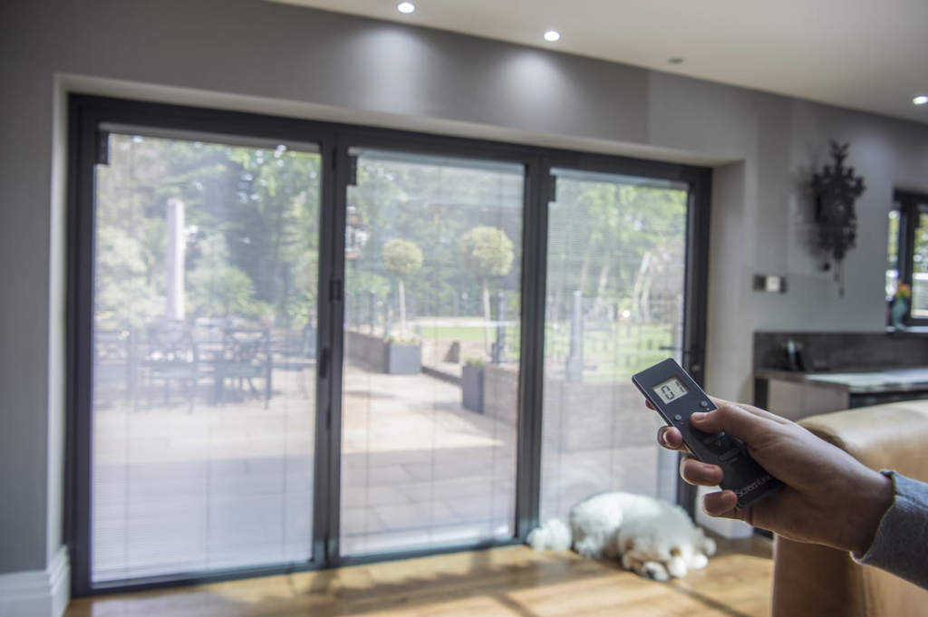 Homeowner demonstrates how to adjust integral blinds with a wireless remote control